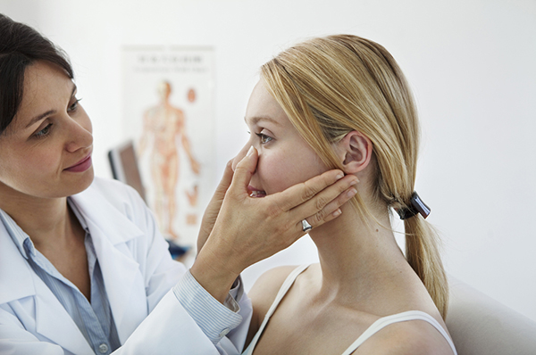 Cosmetic doctor evaluating a female patient 