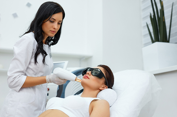 Female patient going through laser skin resurfacing treatment
