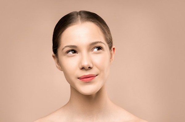 Woman with flawless skin and contoured facial features
