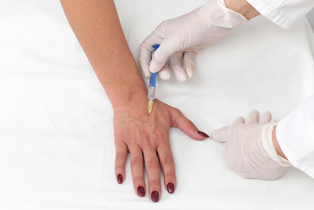  a woman getting Botox injections on her hand