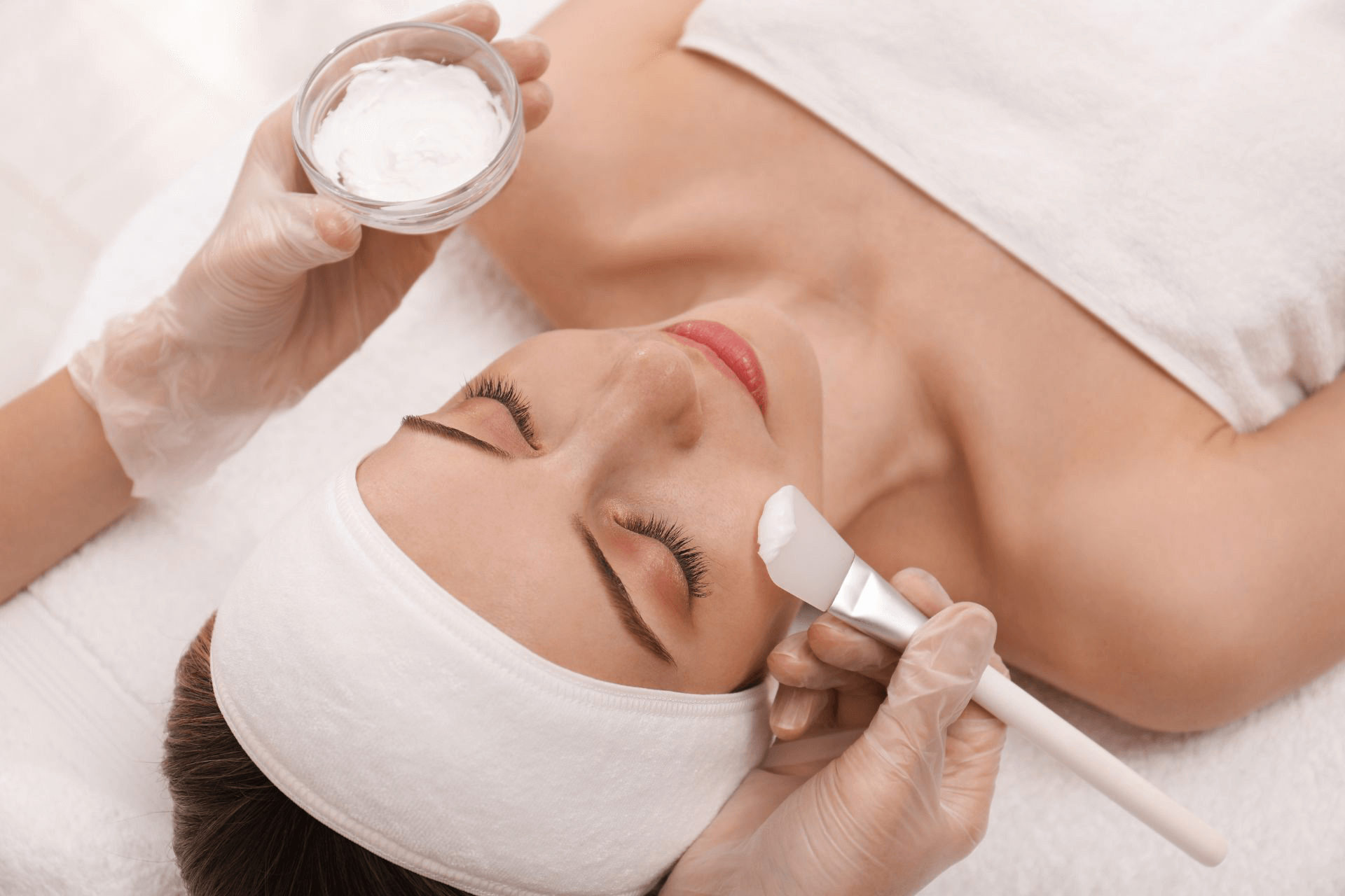 A woman getting a chemical peel applied to her face